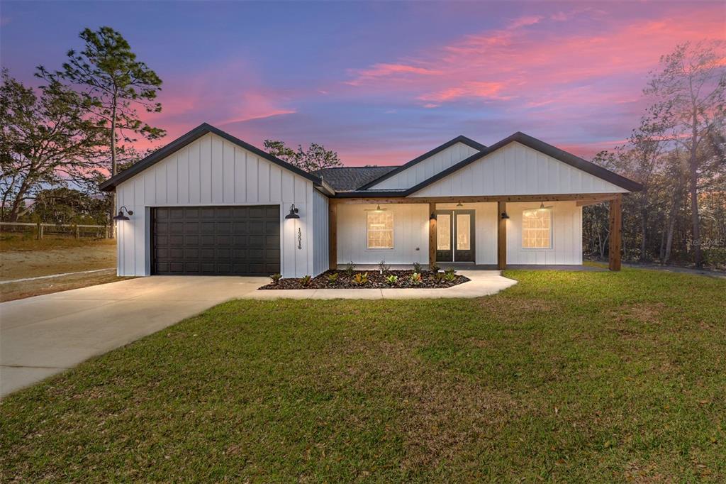 a front view of a house with a yard and garage