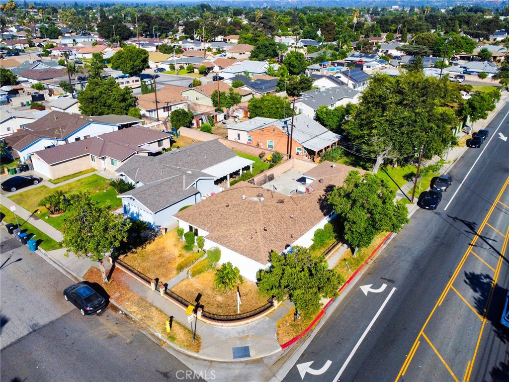 an aerial view of a residential houses with outdoor space and street view