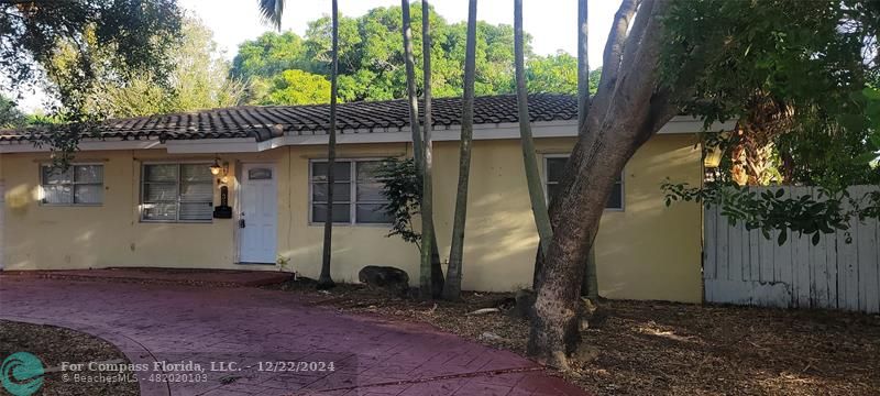 a view of a house with a tree