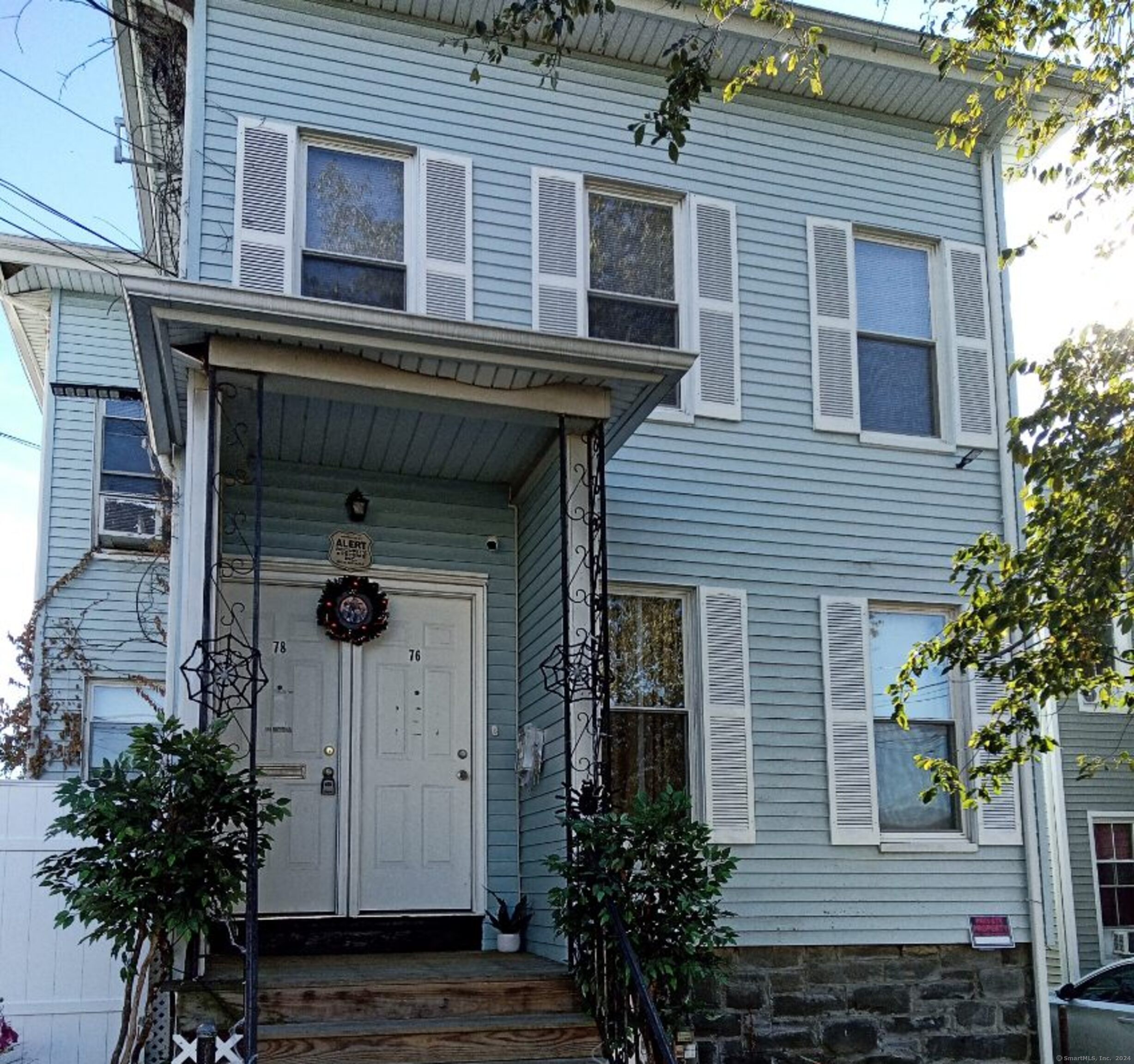 a front view of a house with plants