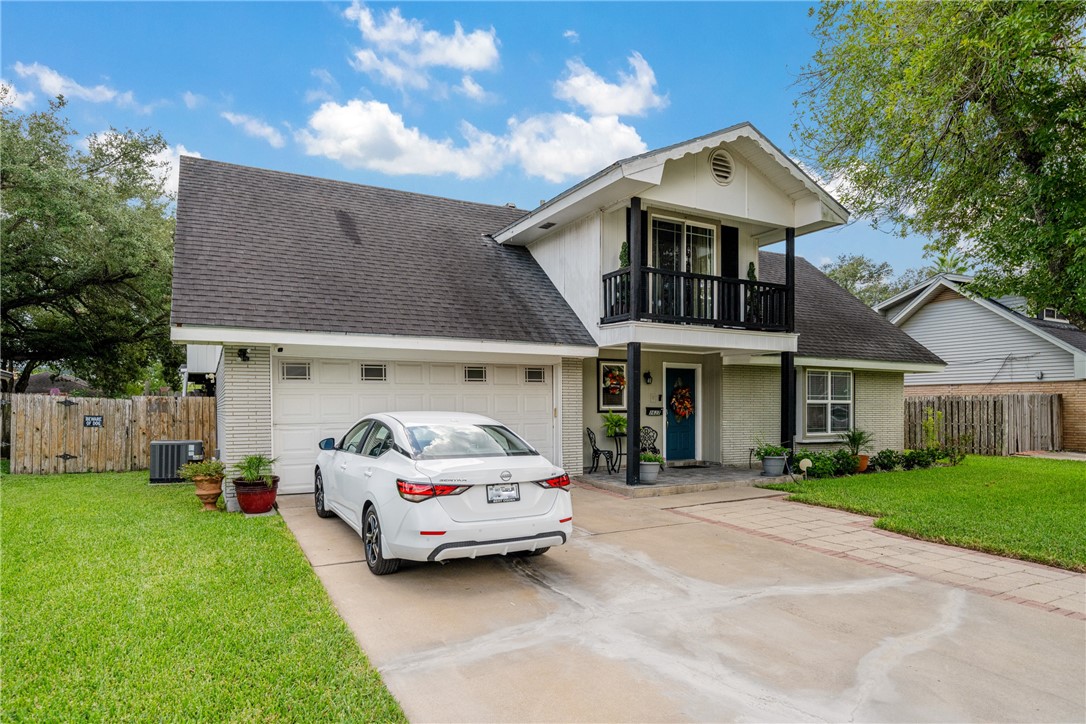 a car parked in front of house with a yard