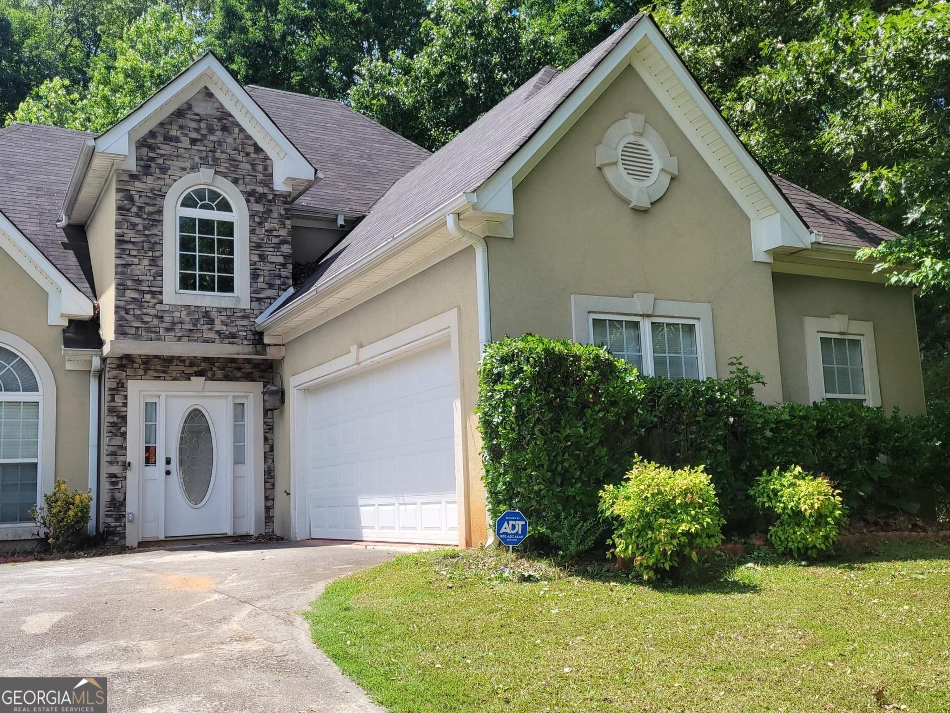 a front view of a house with a yard