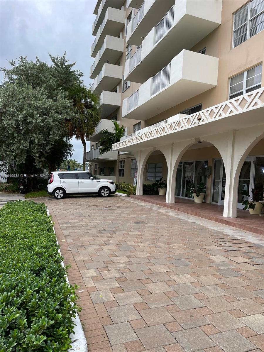 a view of building with cars parked