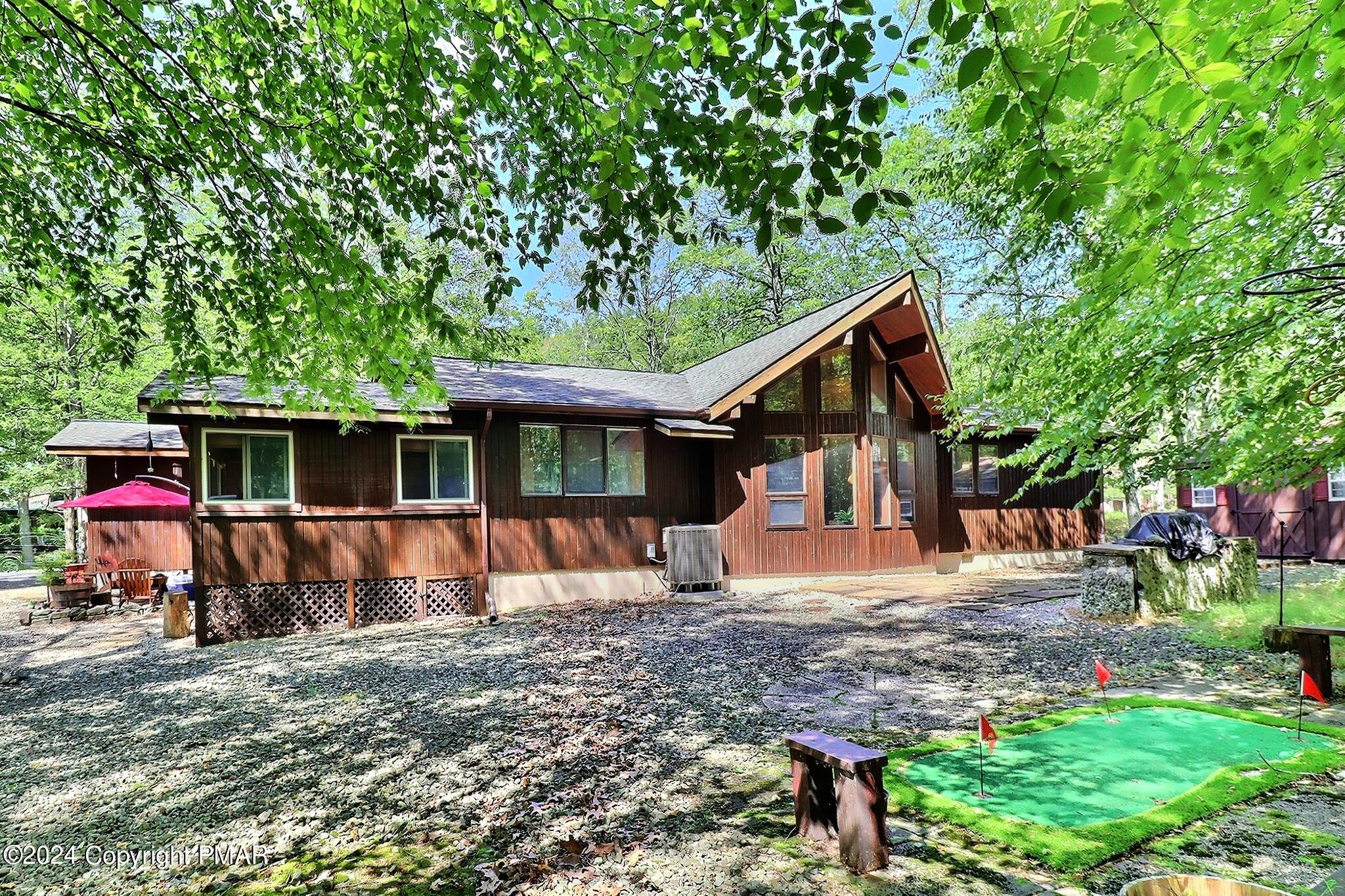 a view of a house with backyard and sitting area