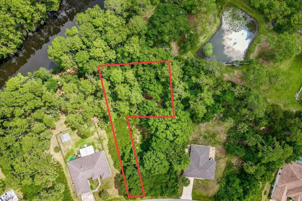 an aerial view of a house with a yard and garden