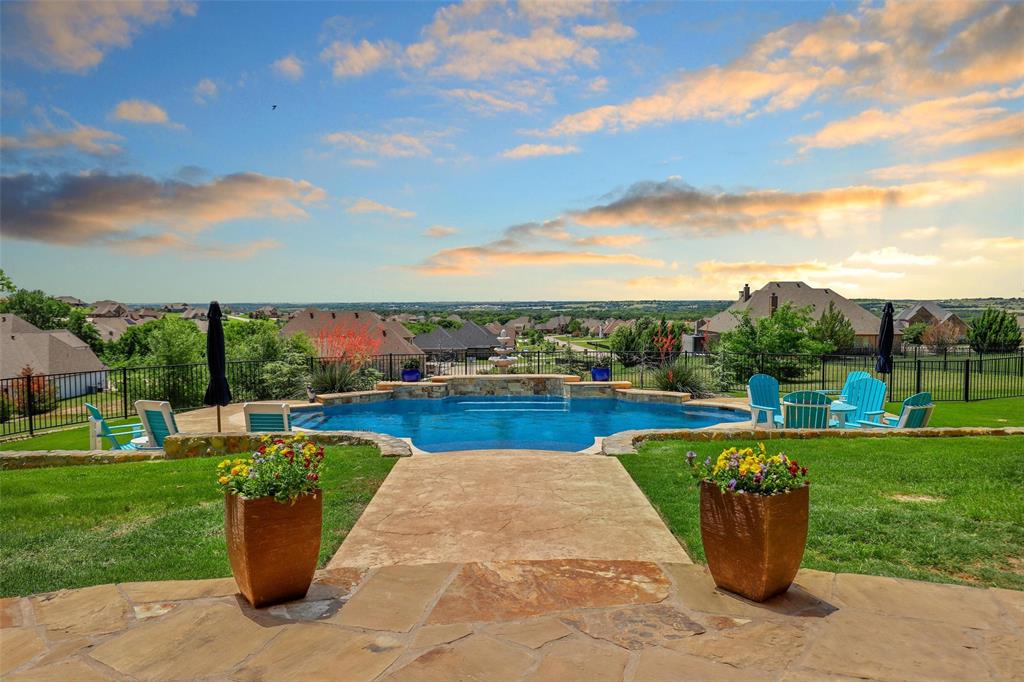 a view of a swimming pool and outdoor seating