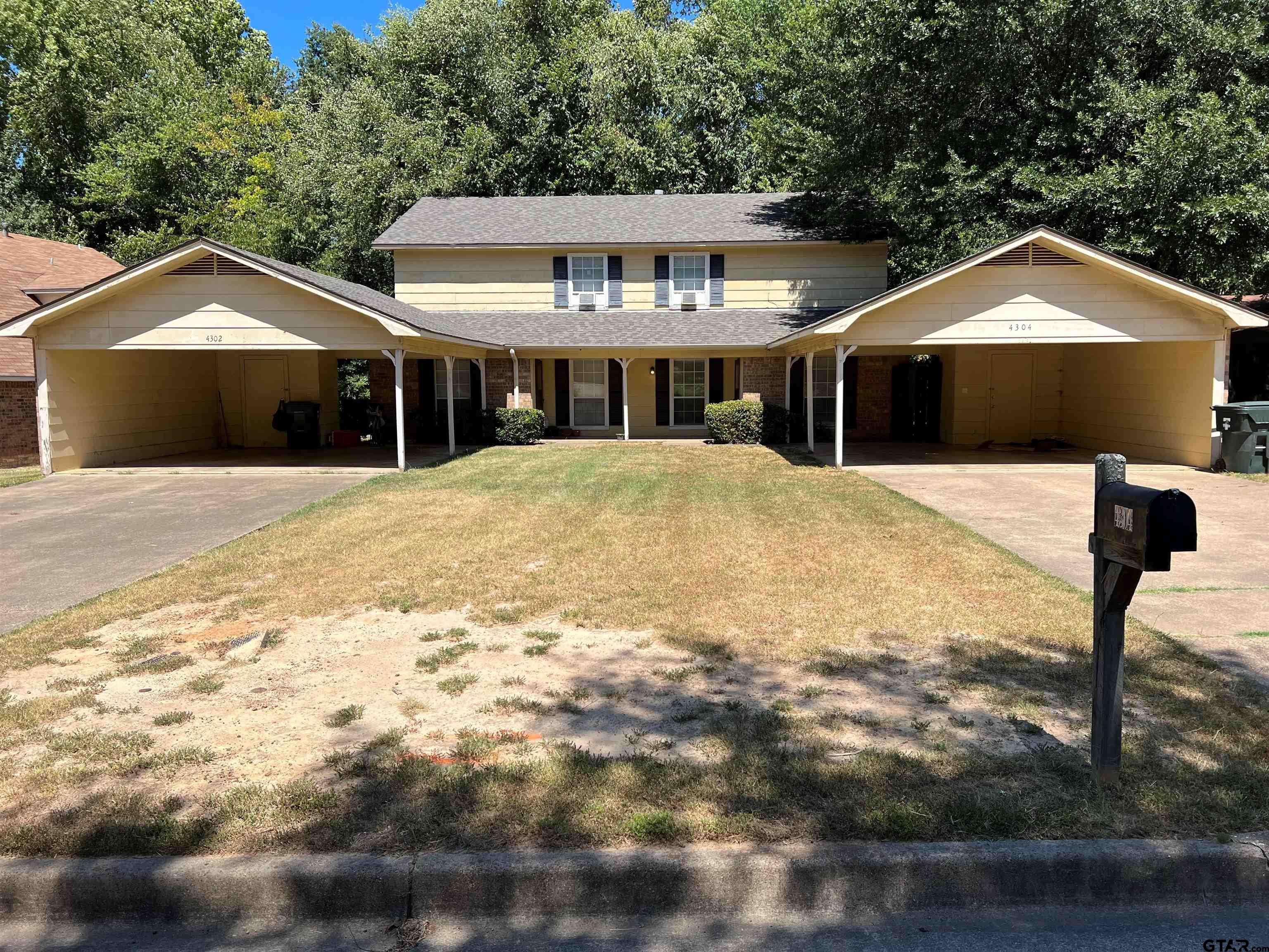 a front view of a house with yard