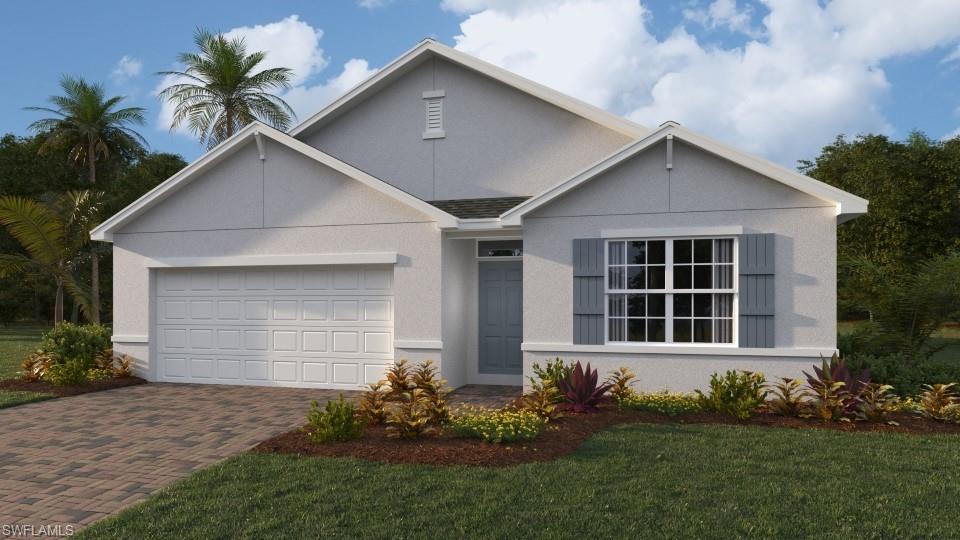 View of front of property featuring a garage and a front lawn