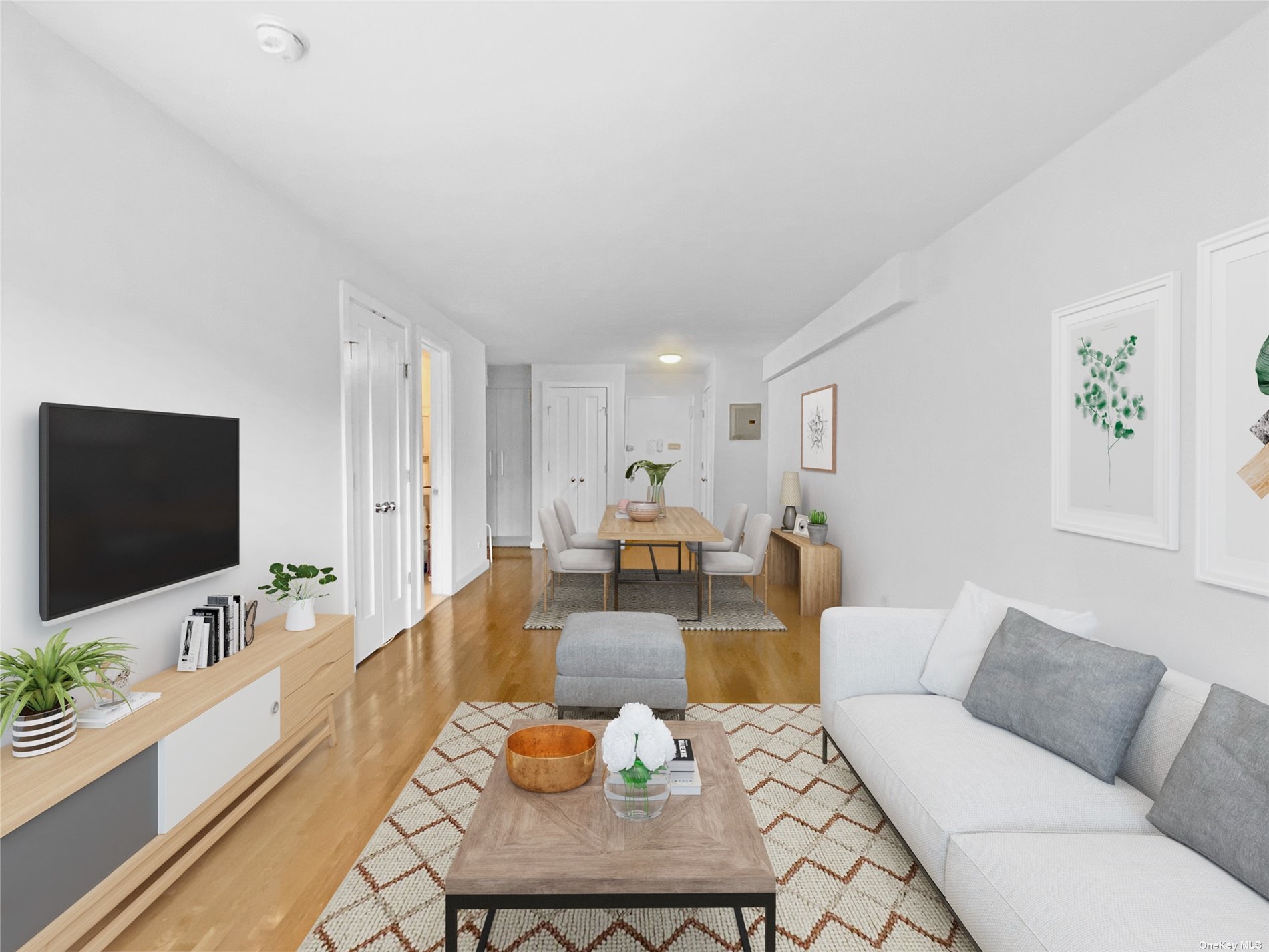 a living room with furniture flat screen tv and wooden floor