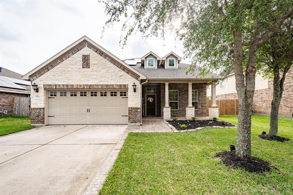 a view of a house with a yard and tree s