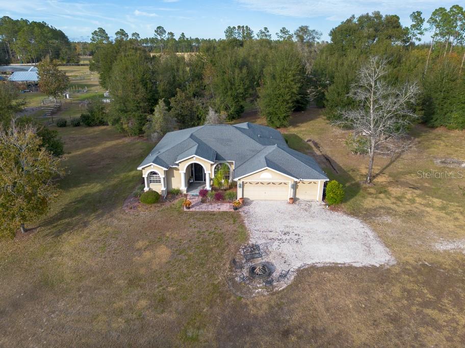 an aerial view of a house with a yard