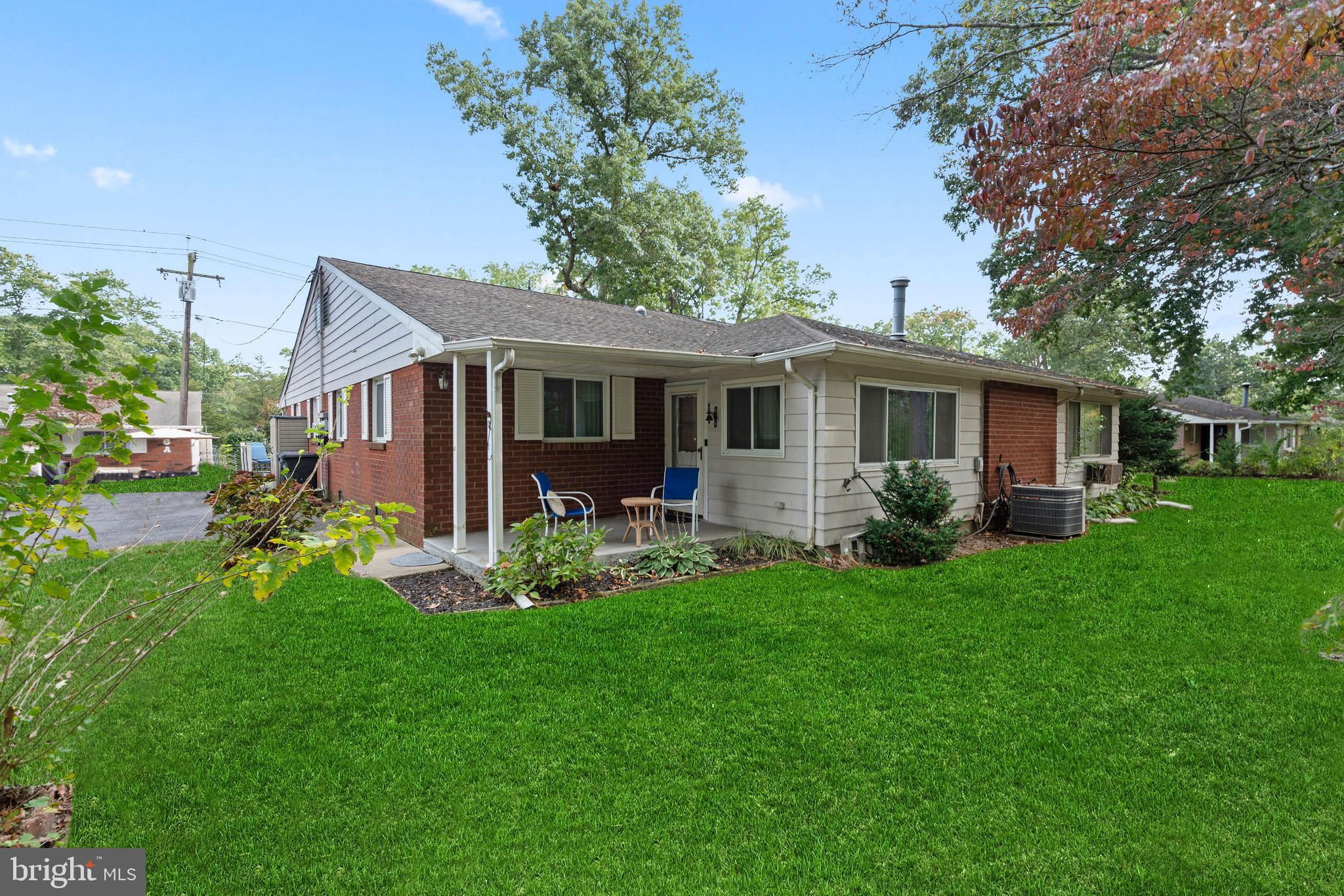 a view of a house with a yard and potted plants