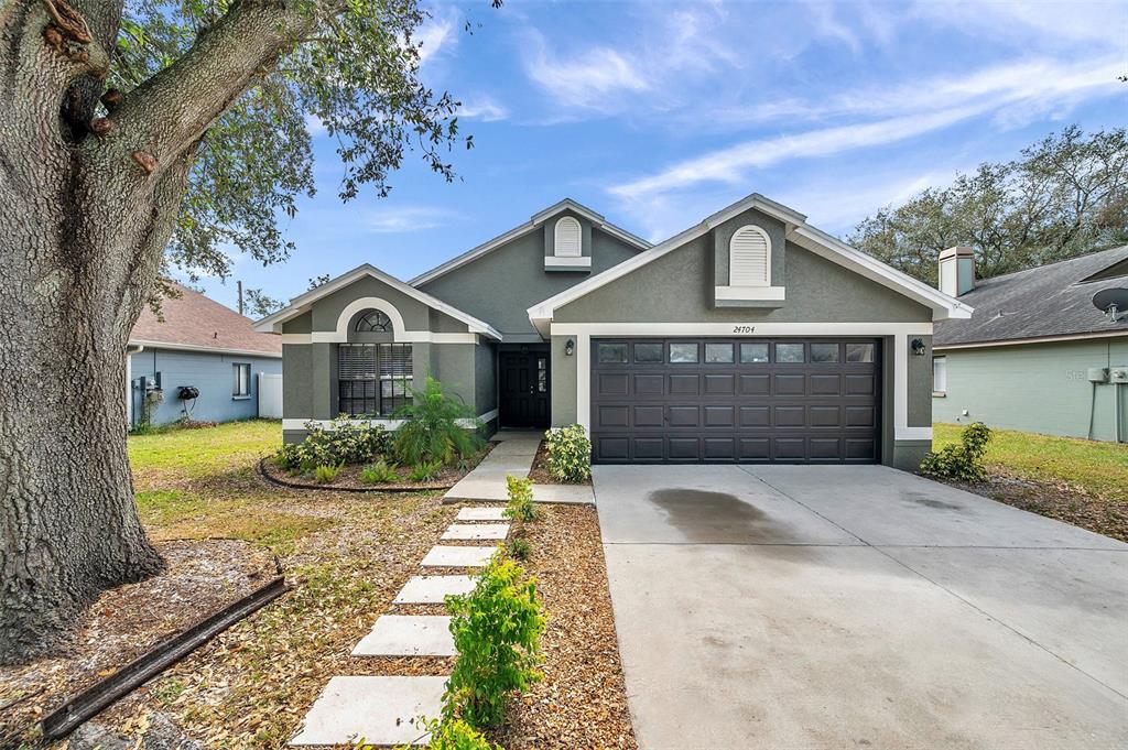 a front view of a house with a yard and garage