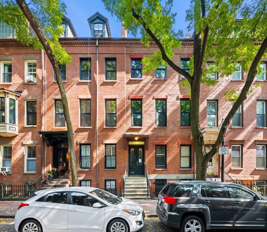 a view of a car park in front of a brick house