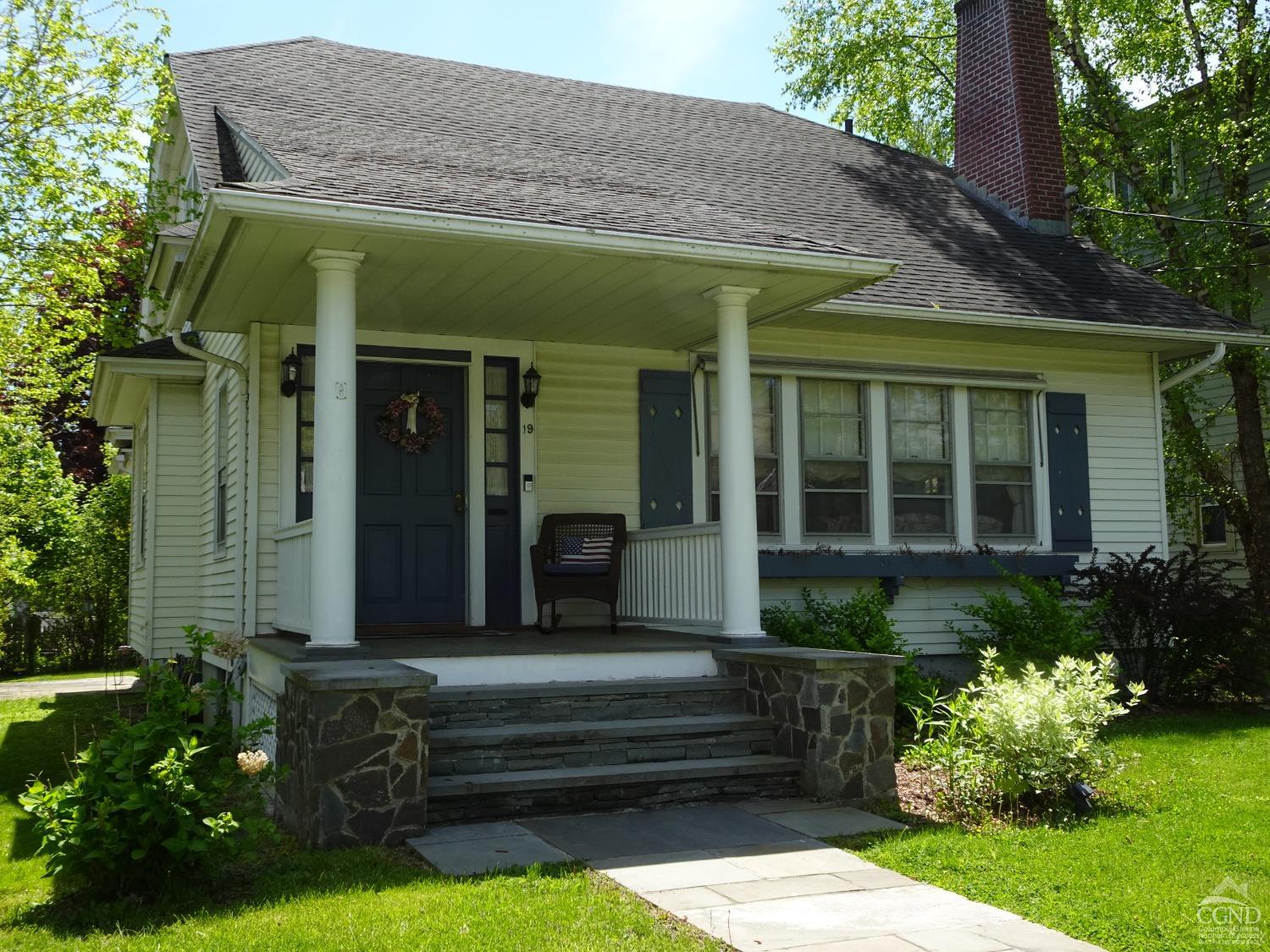 a front view of a house with a garden