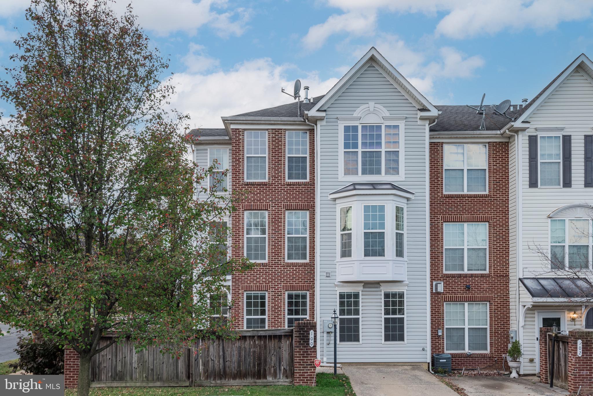 a front view of a residential apartment building with a yard