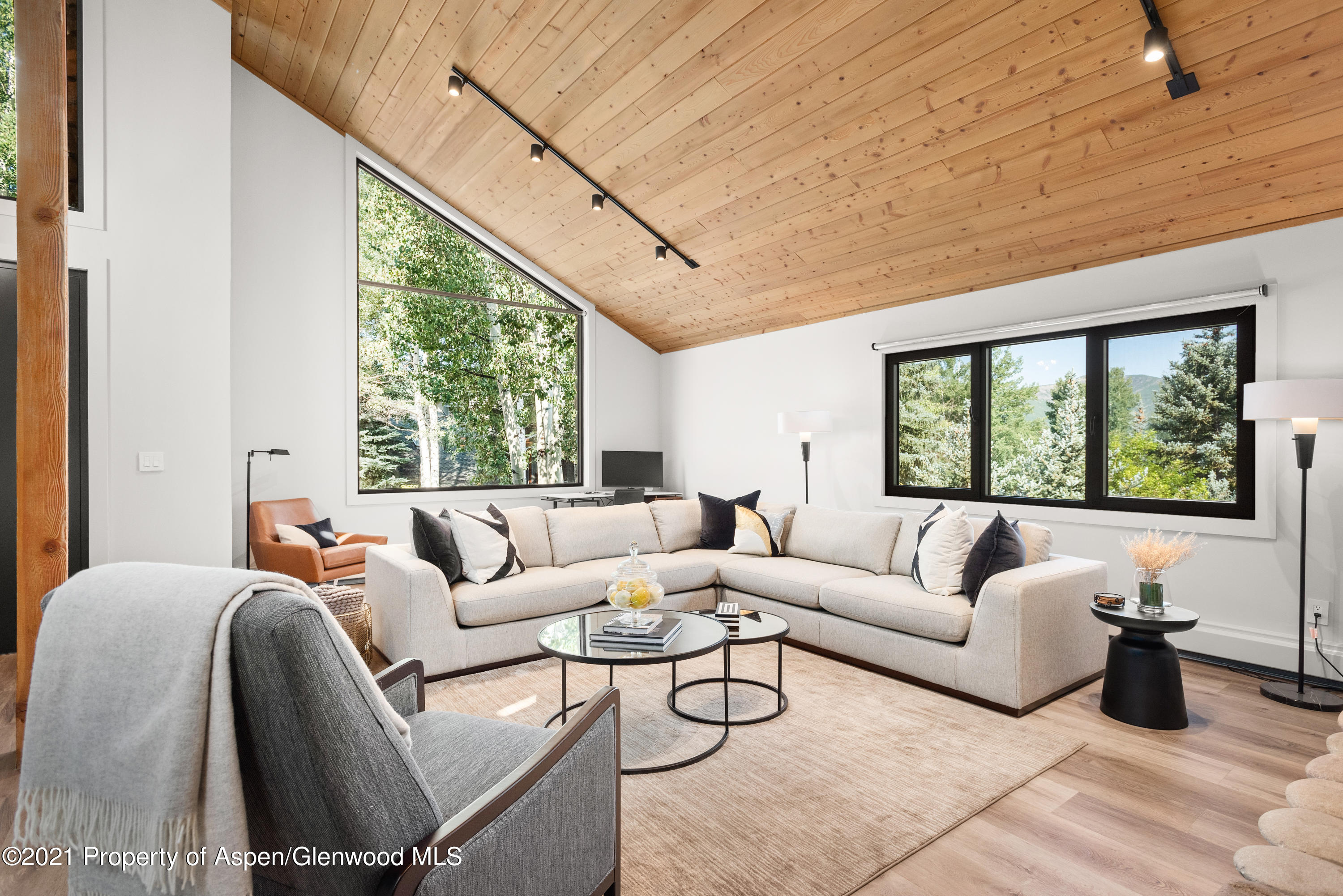 a living room with furniture and large windows