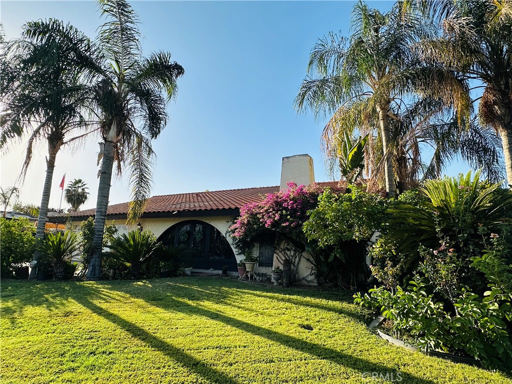 a view of swimming pool with a garden and patio