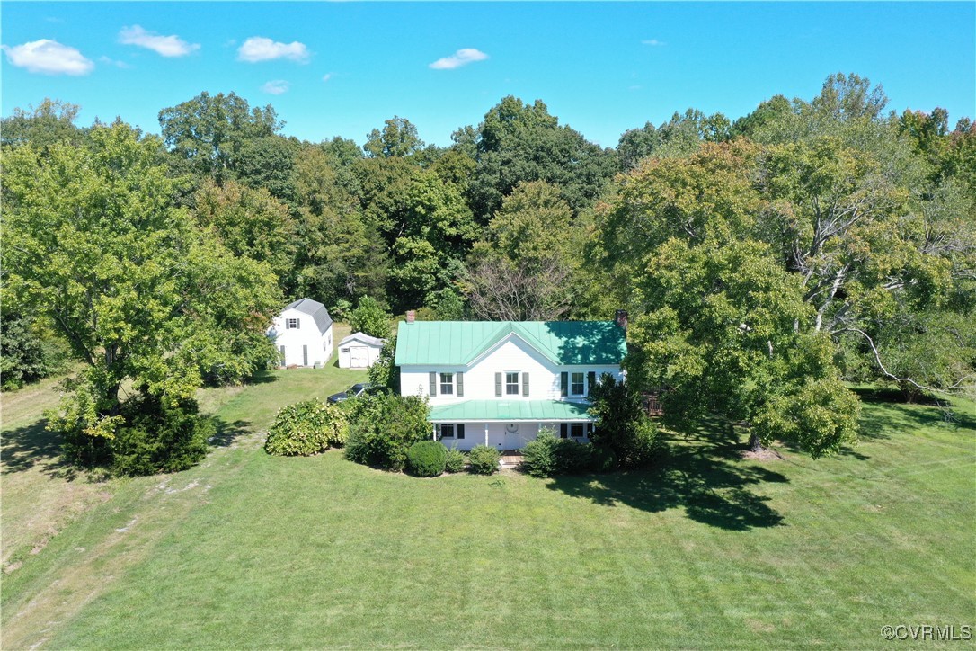 a view of a house with a yard and garden