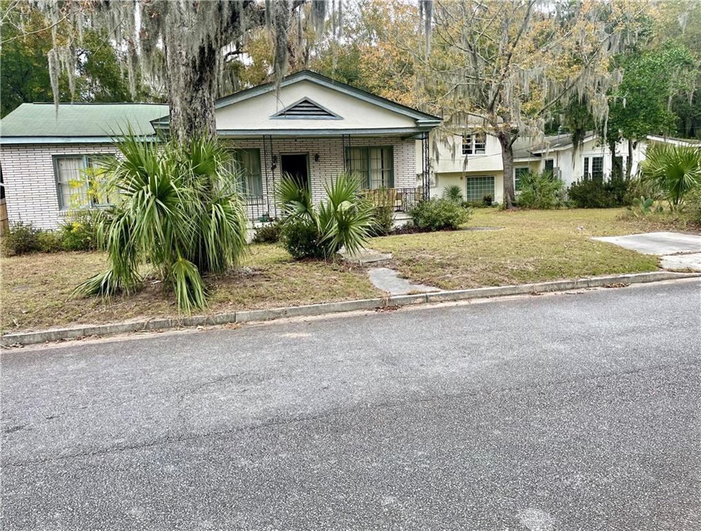 a front view of a house with a garden