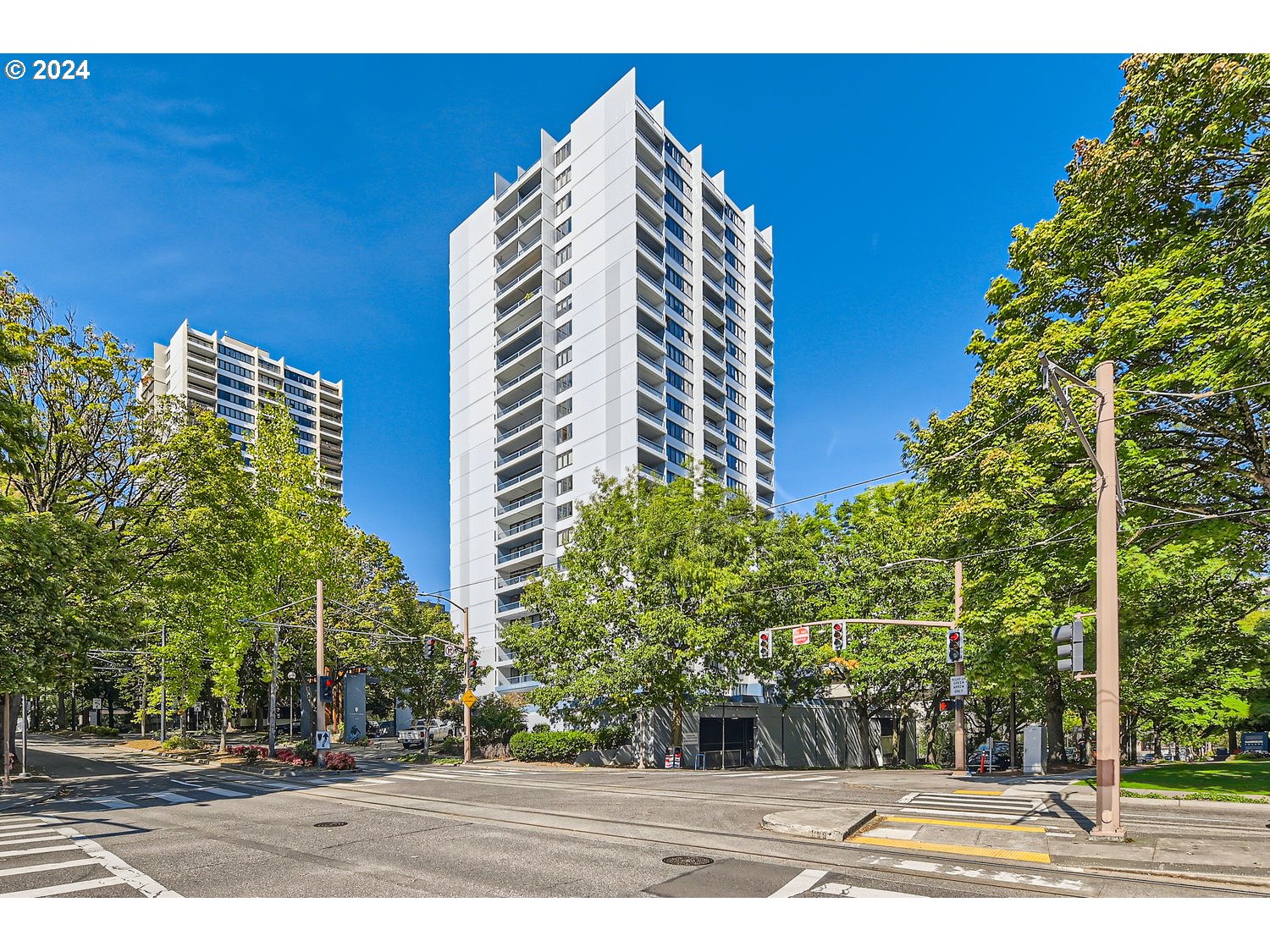 a view of a tall building next to a road