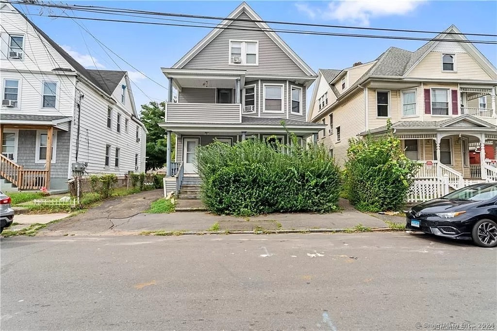 a front view of a house with a garden