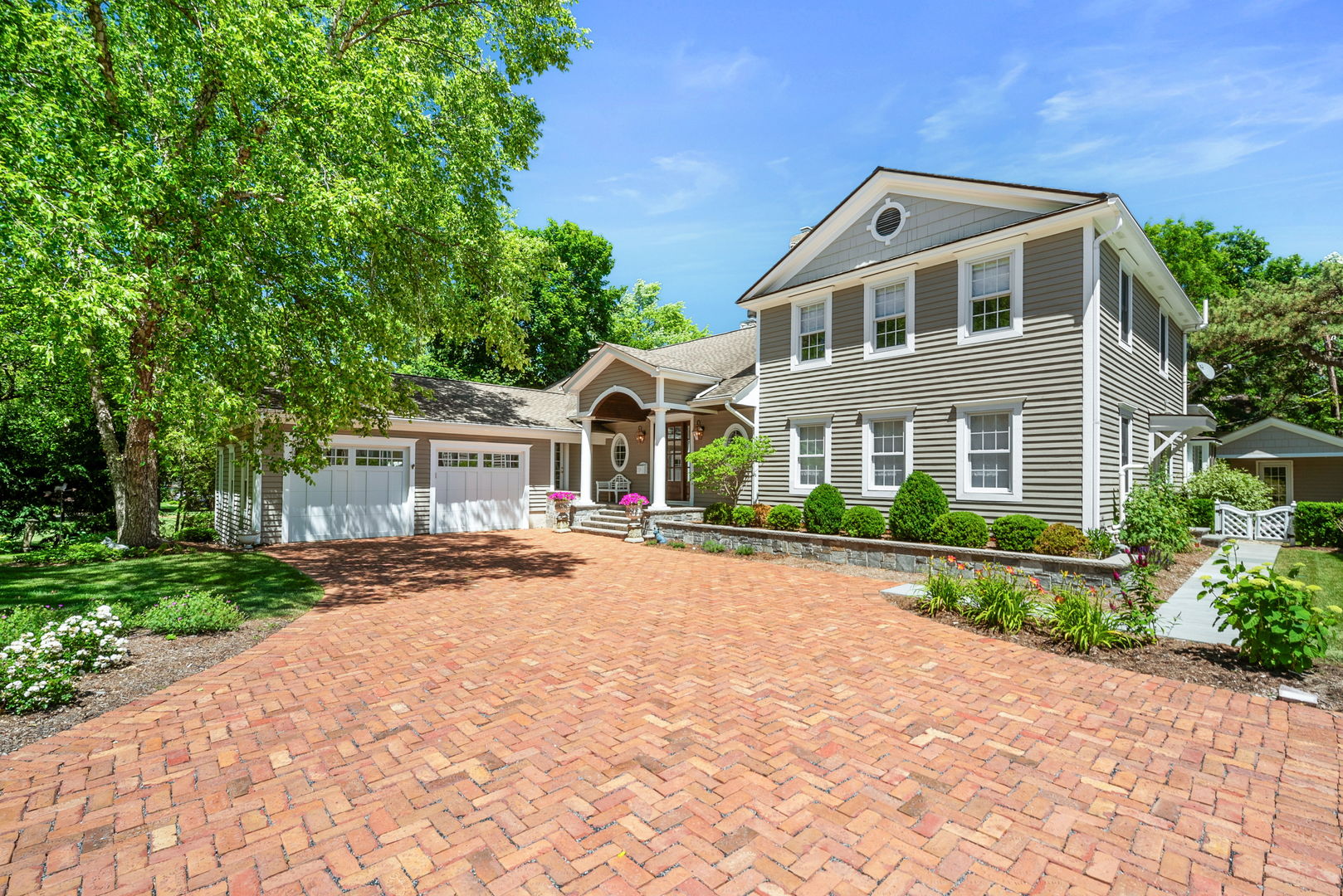 a front view of a house with a garden