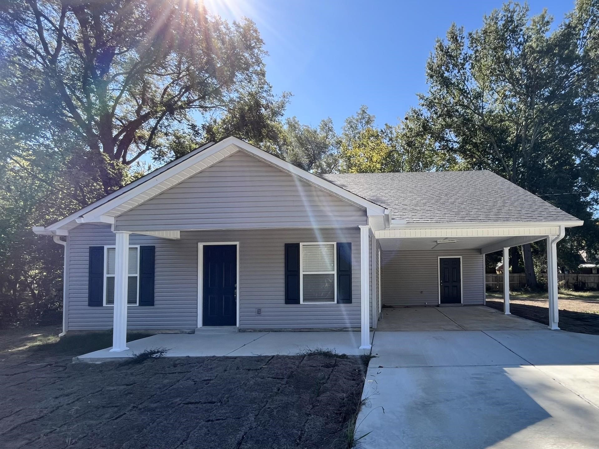 Single story home featuring a carport