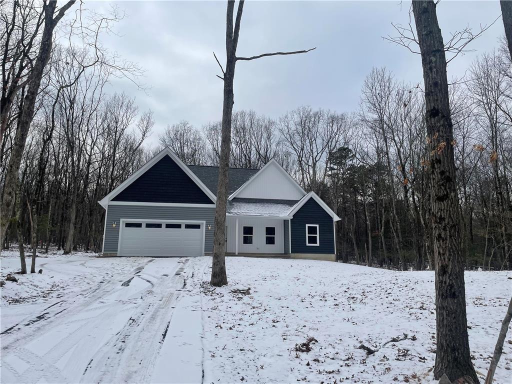 a front view of a house with a yard covered with snow