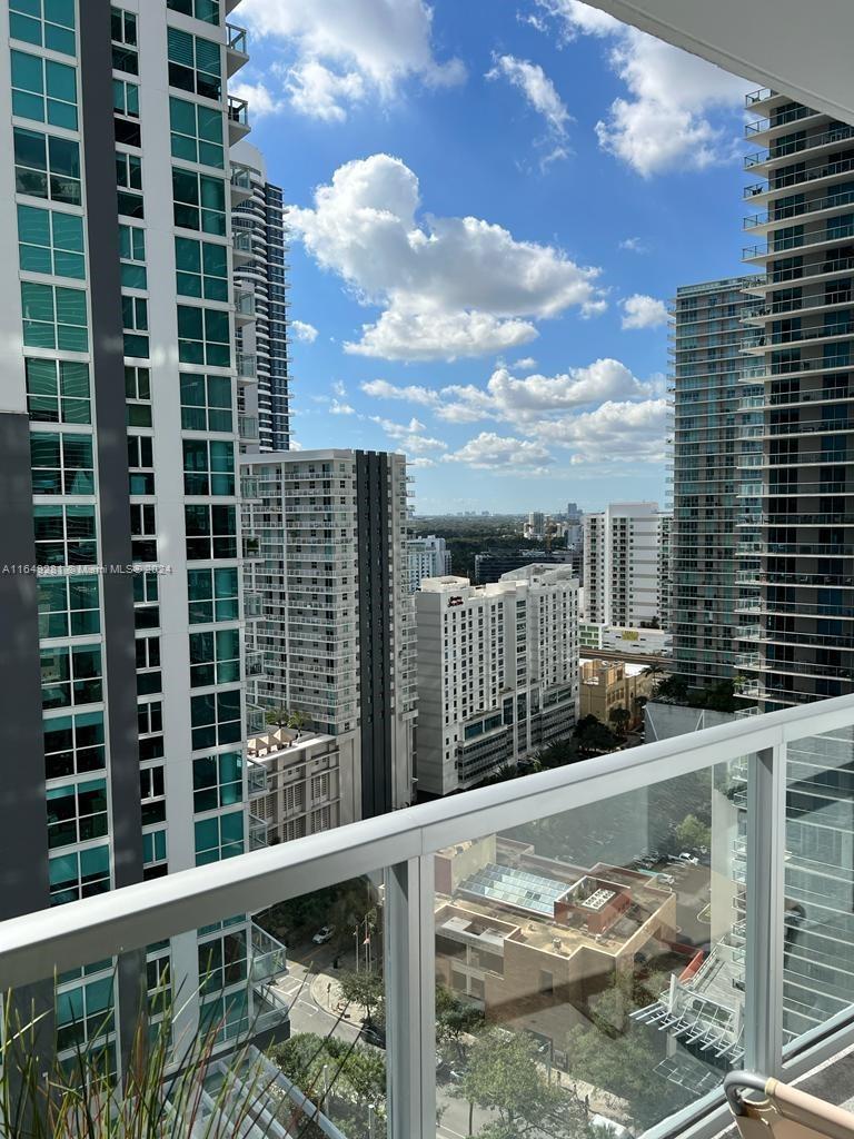 a view of balcony with a tall buildings