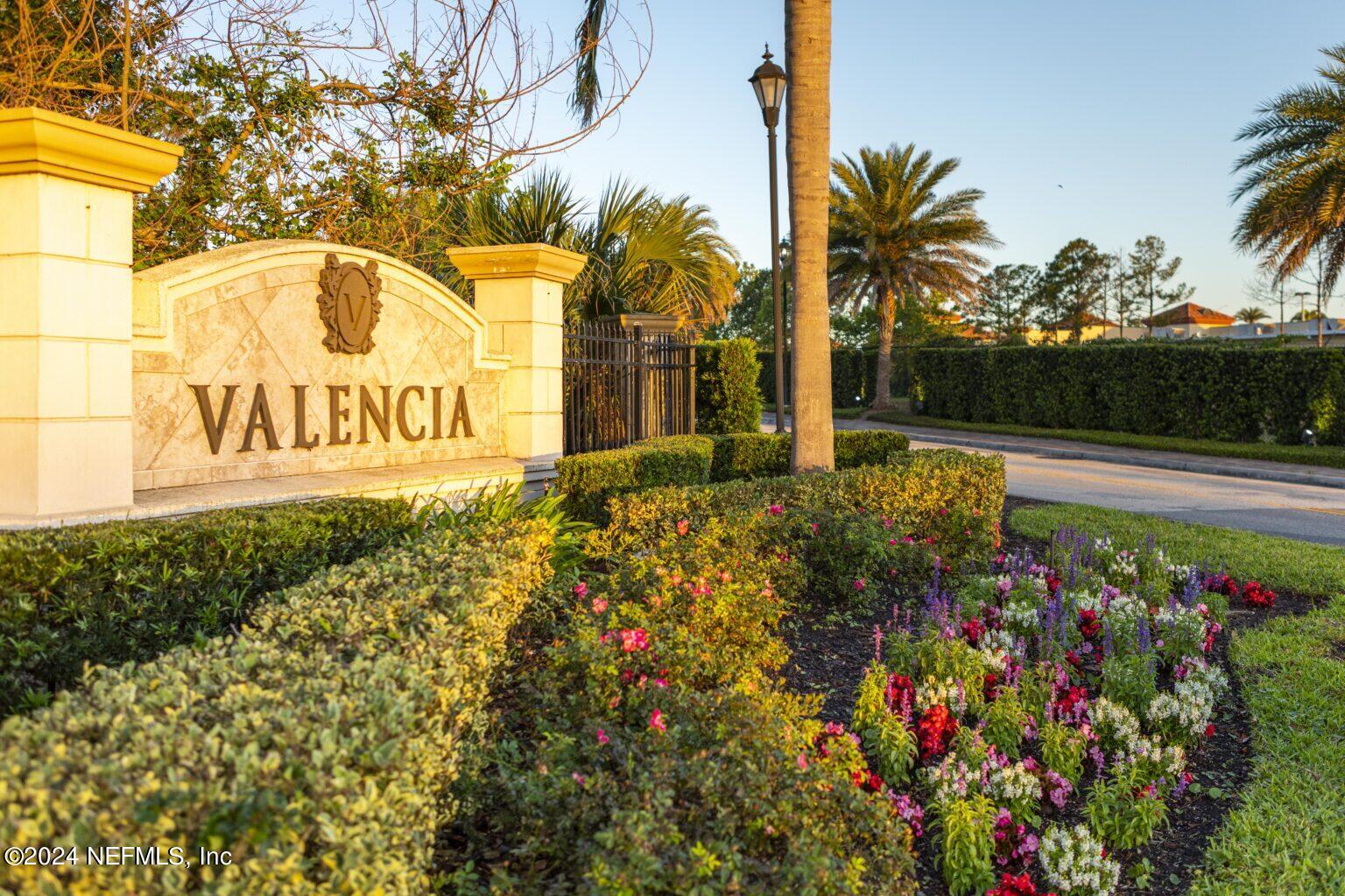 a view of sign board with flower around