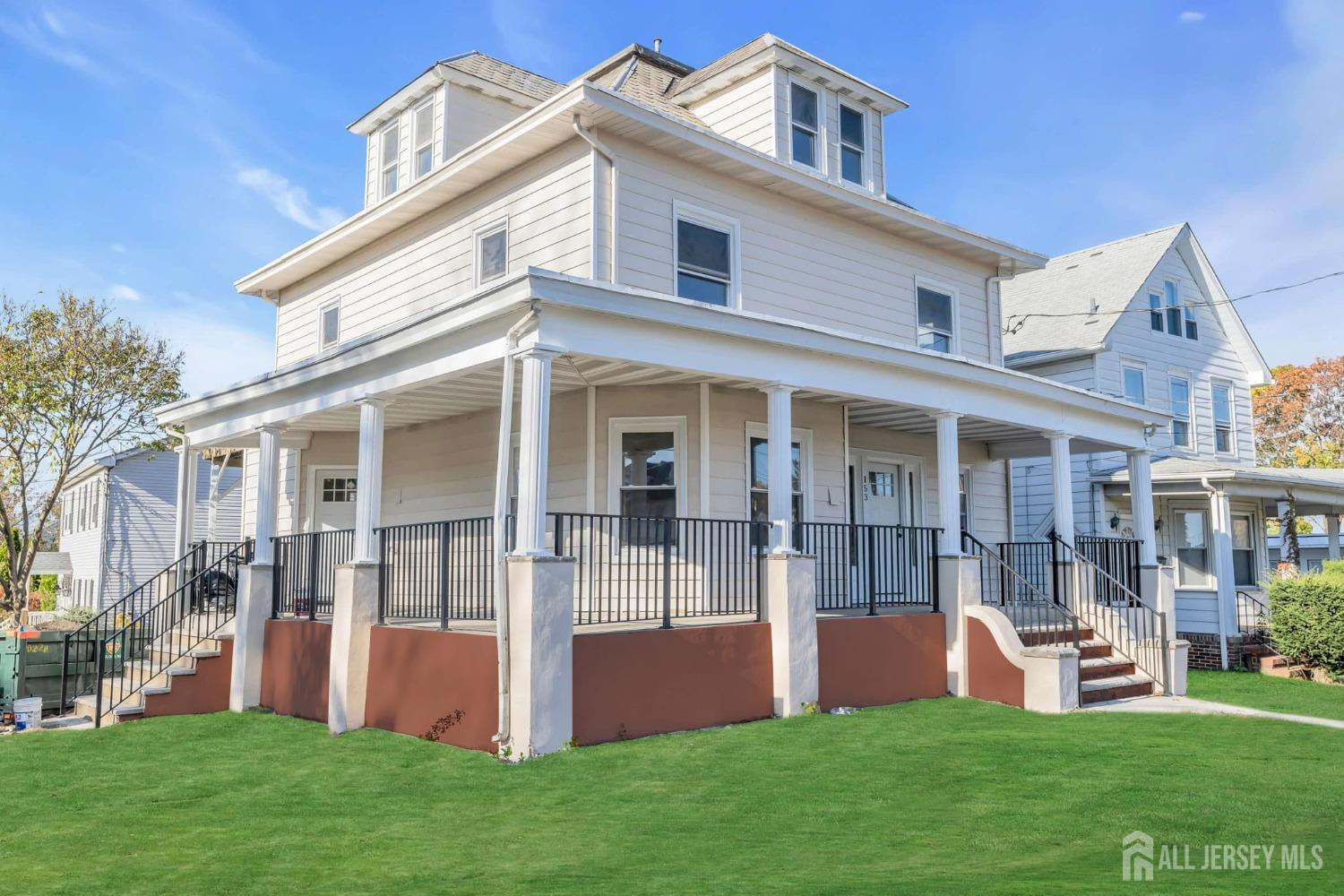 a front view of house with yard and outdoor seating