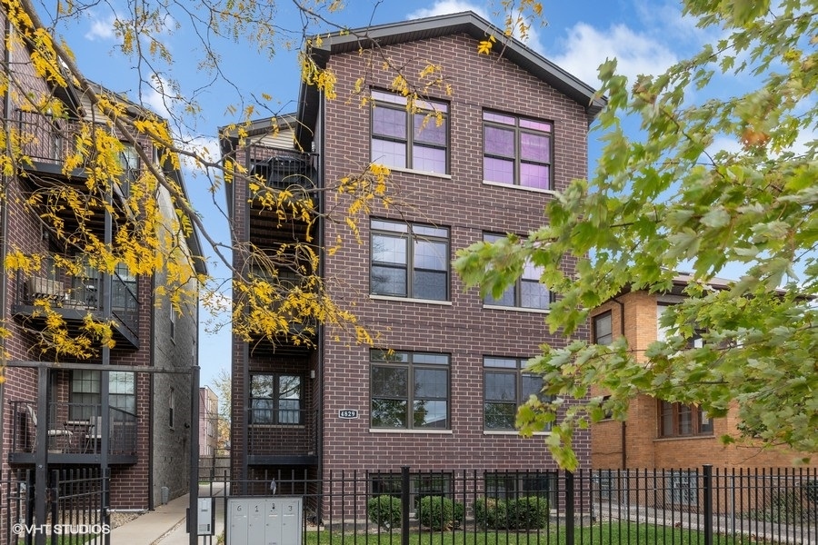 a view of a brick house with many windows