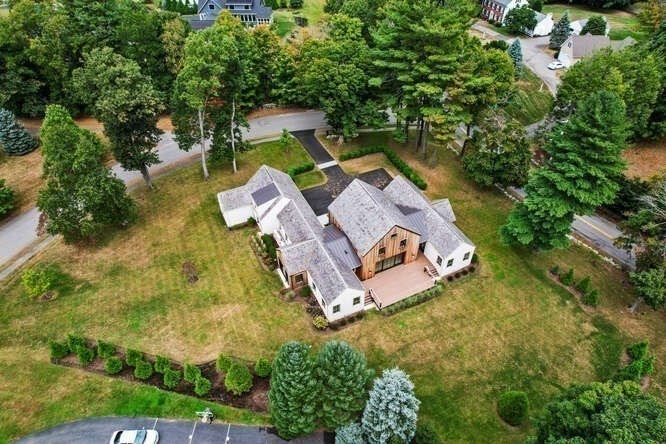 an aerial view of a house with swimming pool and outdoor space