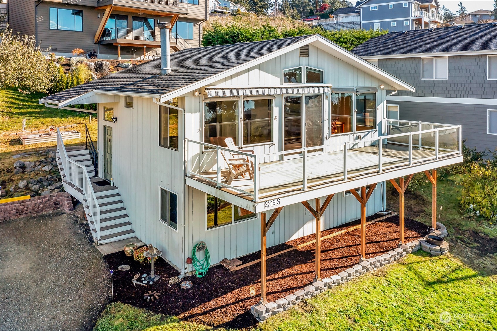 a view of a house with a yard and sitting area