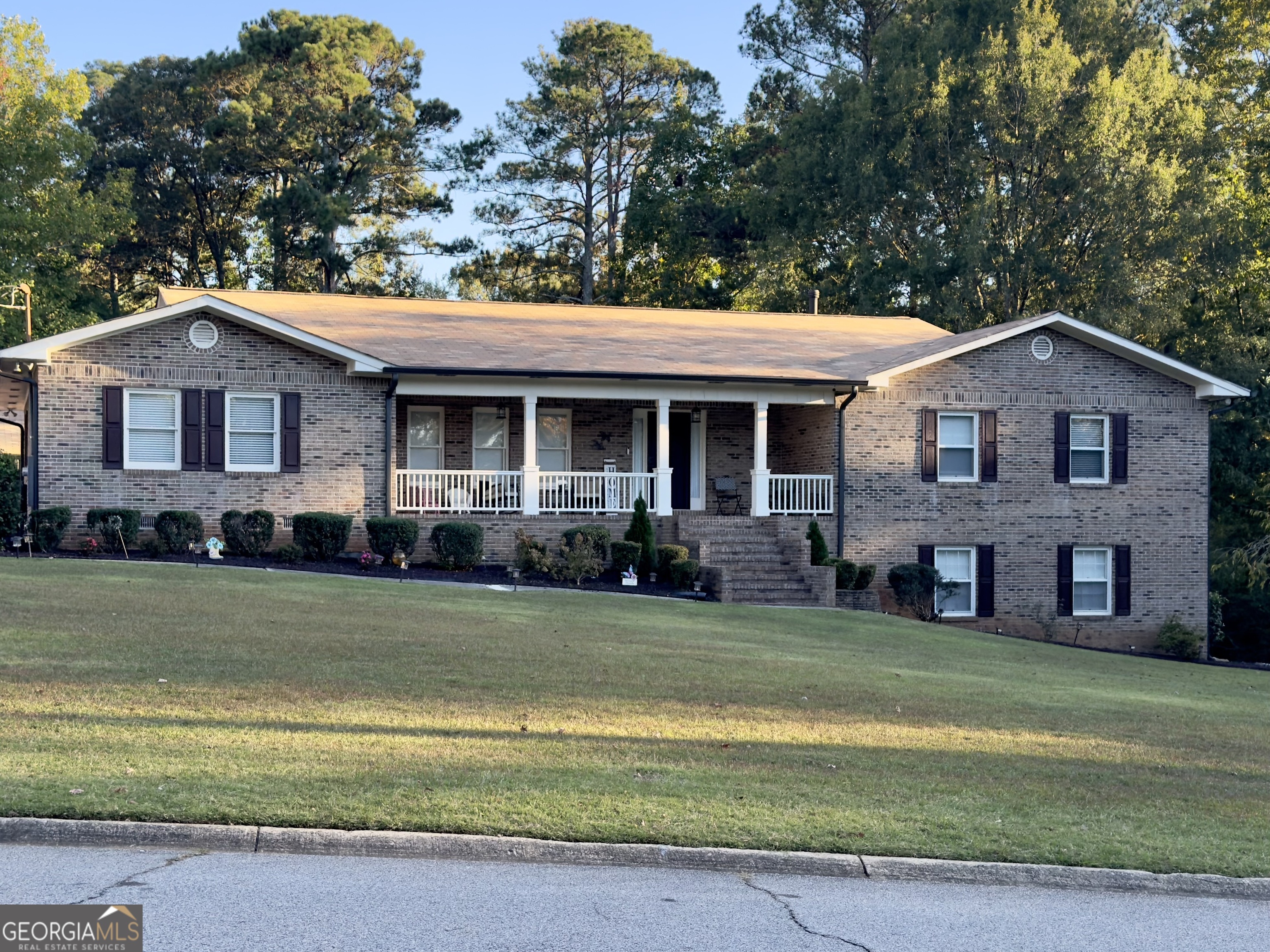 a front view of a house with a garden