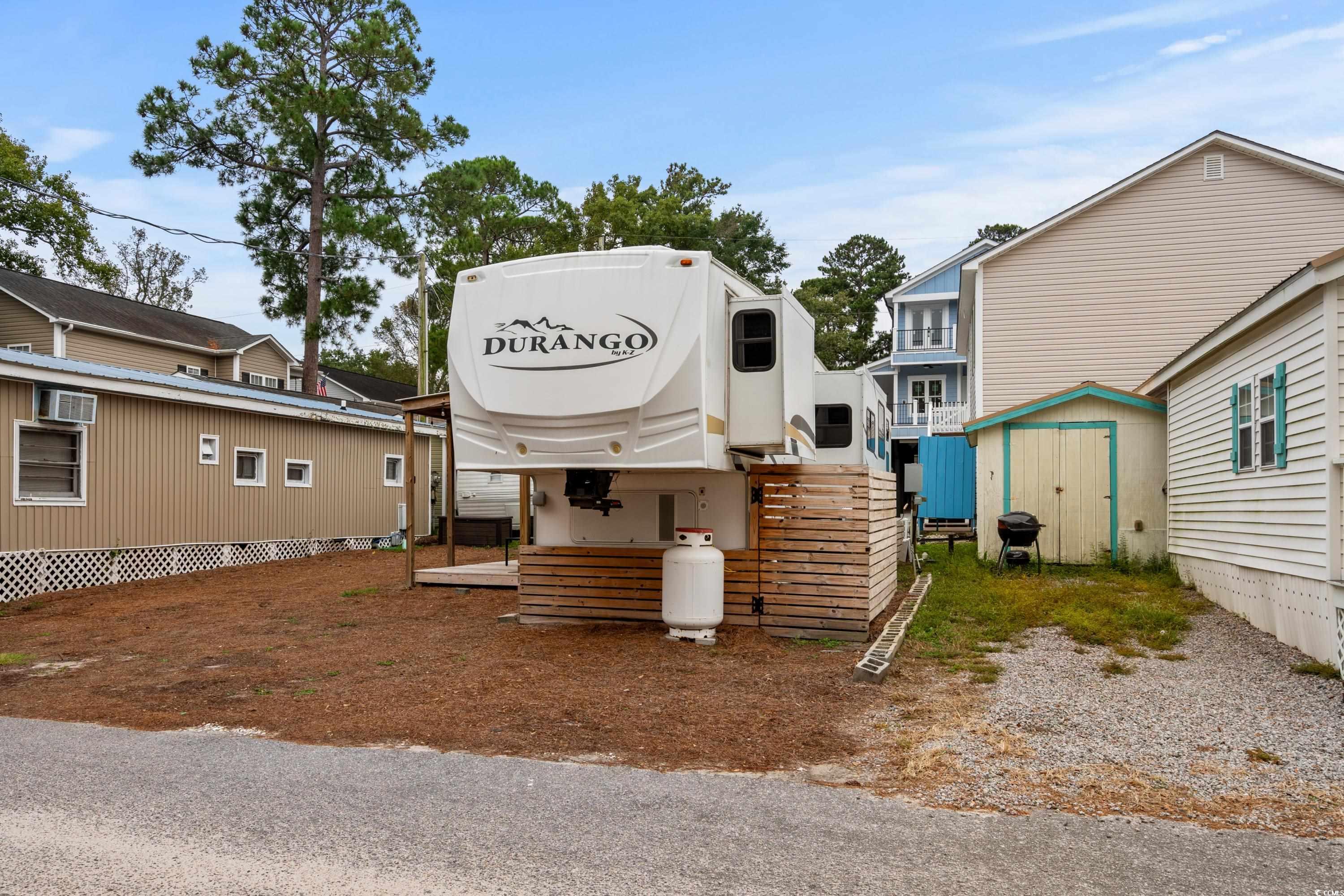 View of front of home with a storage shed