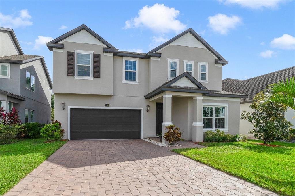 a front view of a house with a yard and garage