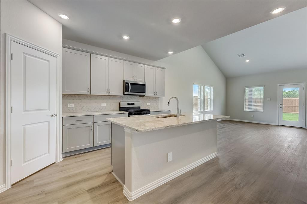 a kitchen with cabinets a sink and appliances