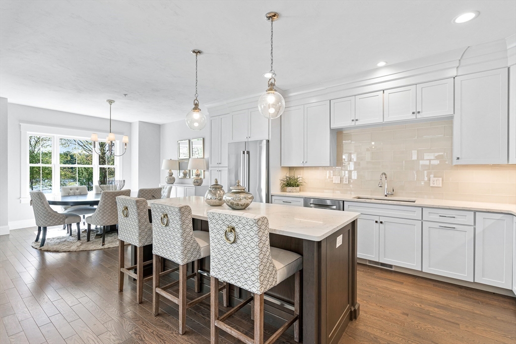 a large kitchen with a table and chairs