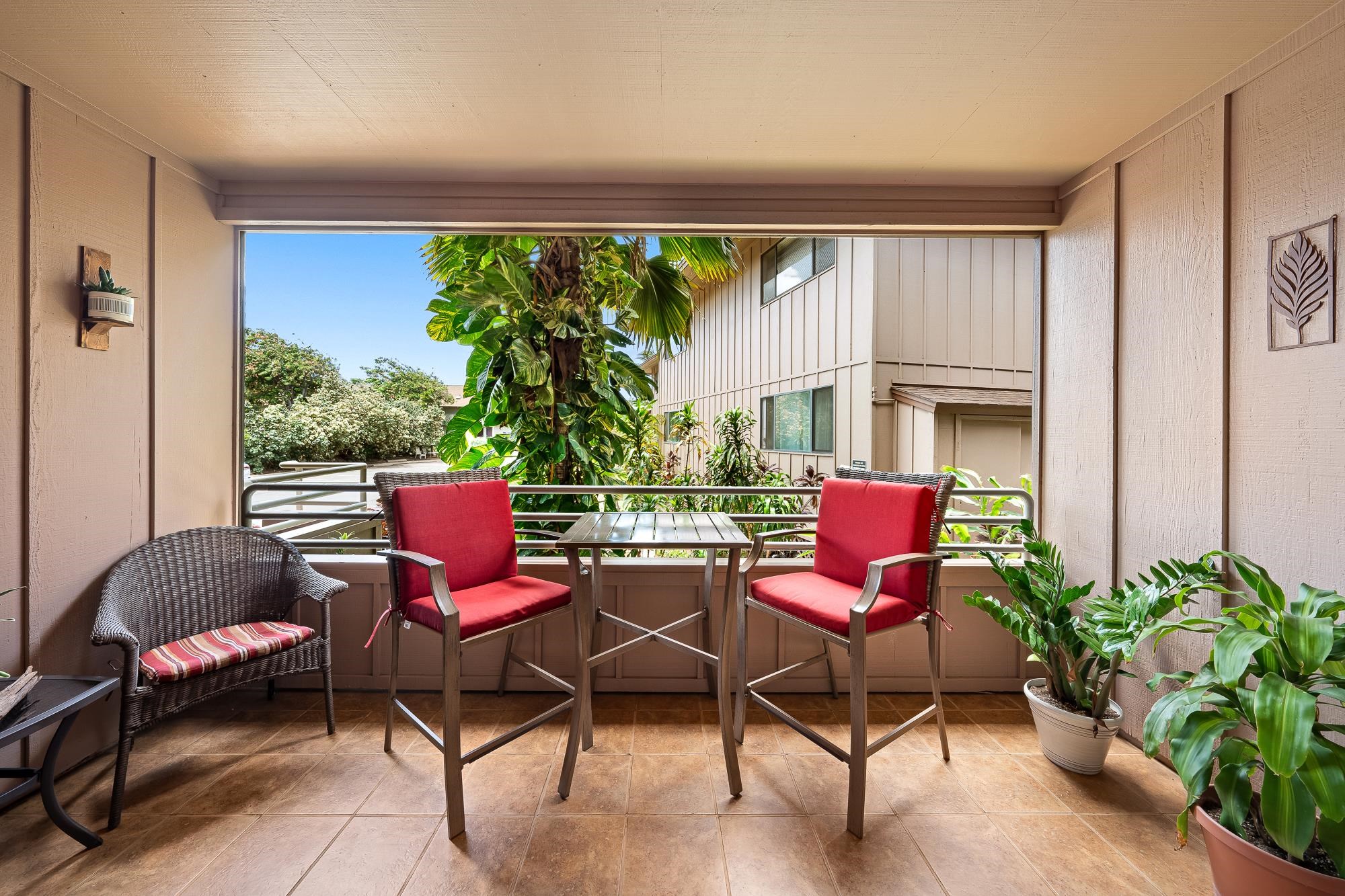 a balcony with furniture and a potted plant