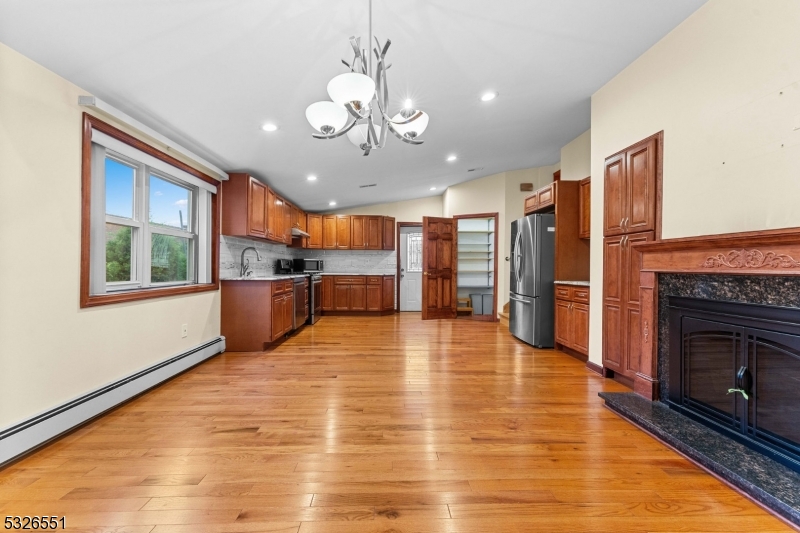 a view of a kitchen with a stove cabinets and wooden floor