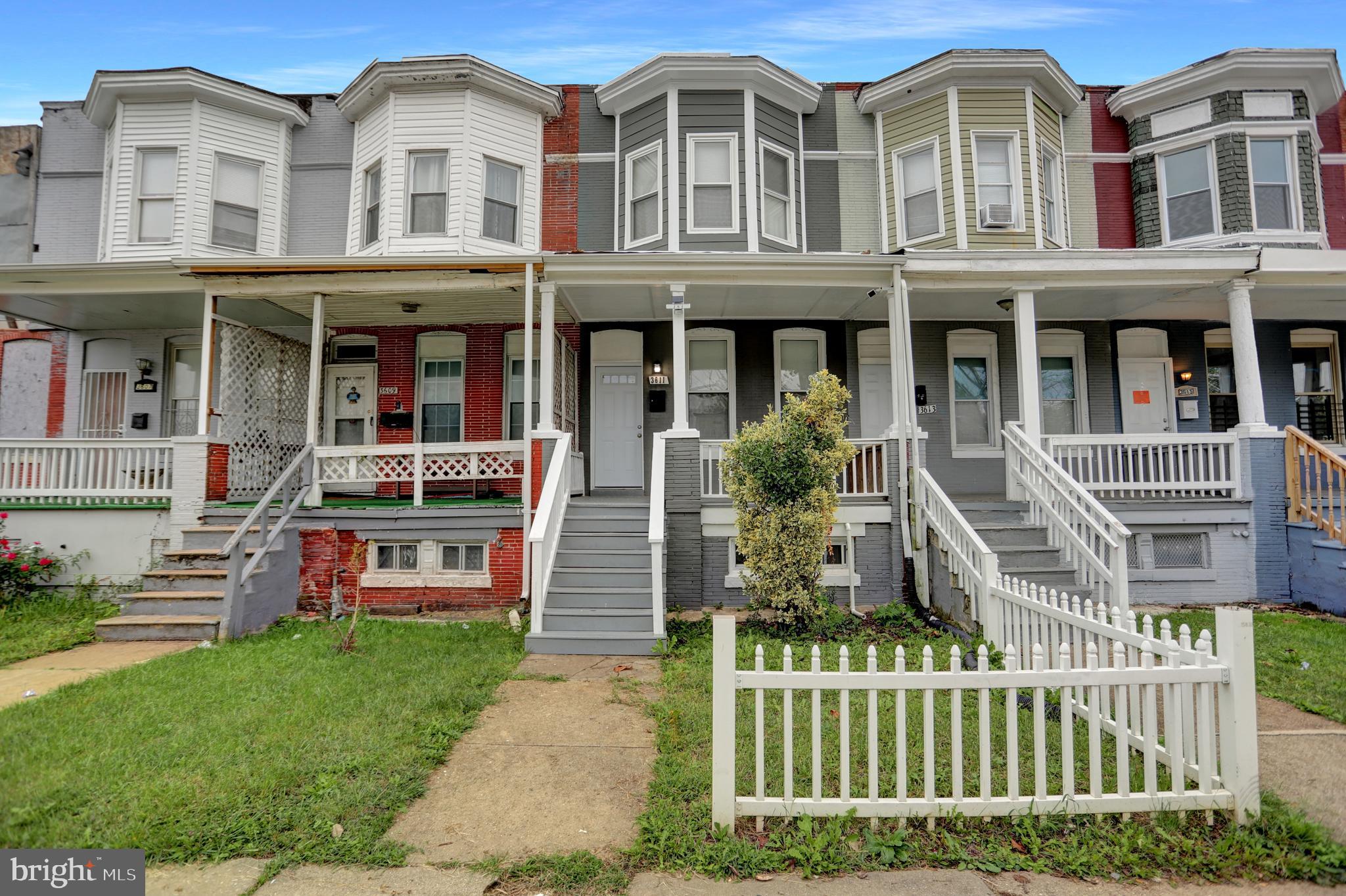 a front view of a residential apartment building with a yard