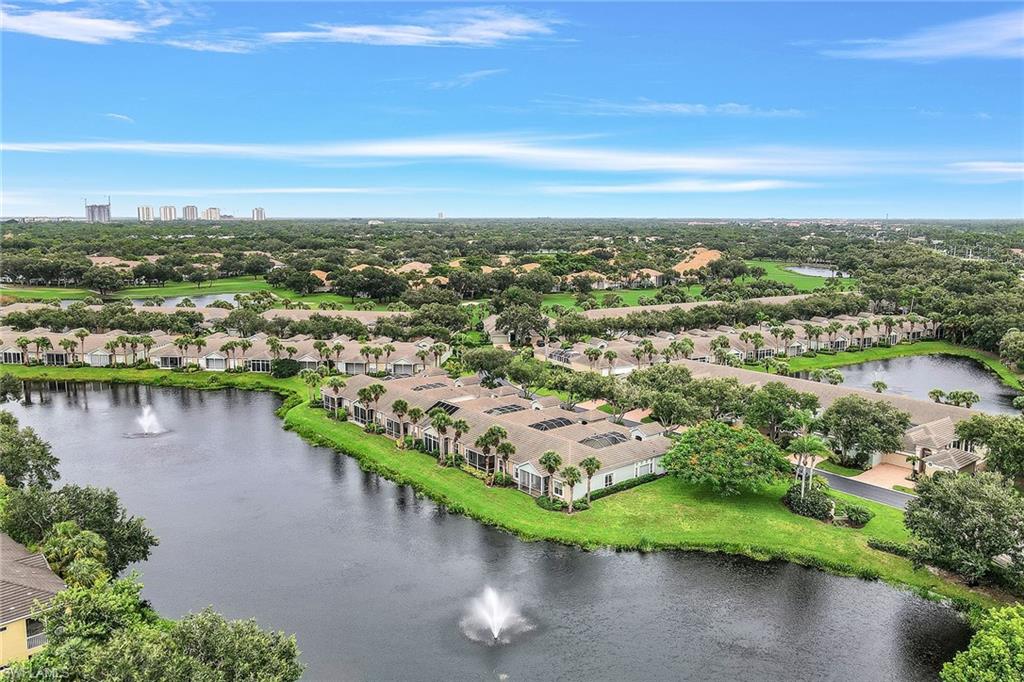 an aerial view of a city with lots of residential buildings lake and ocean view