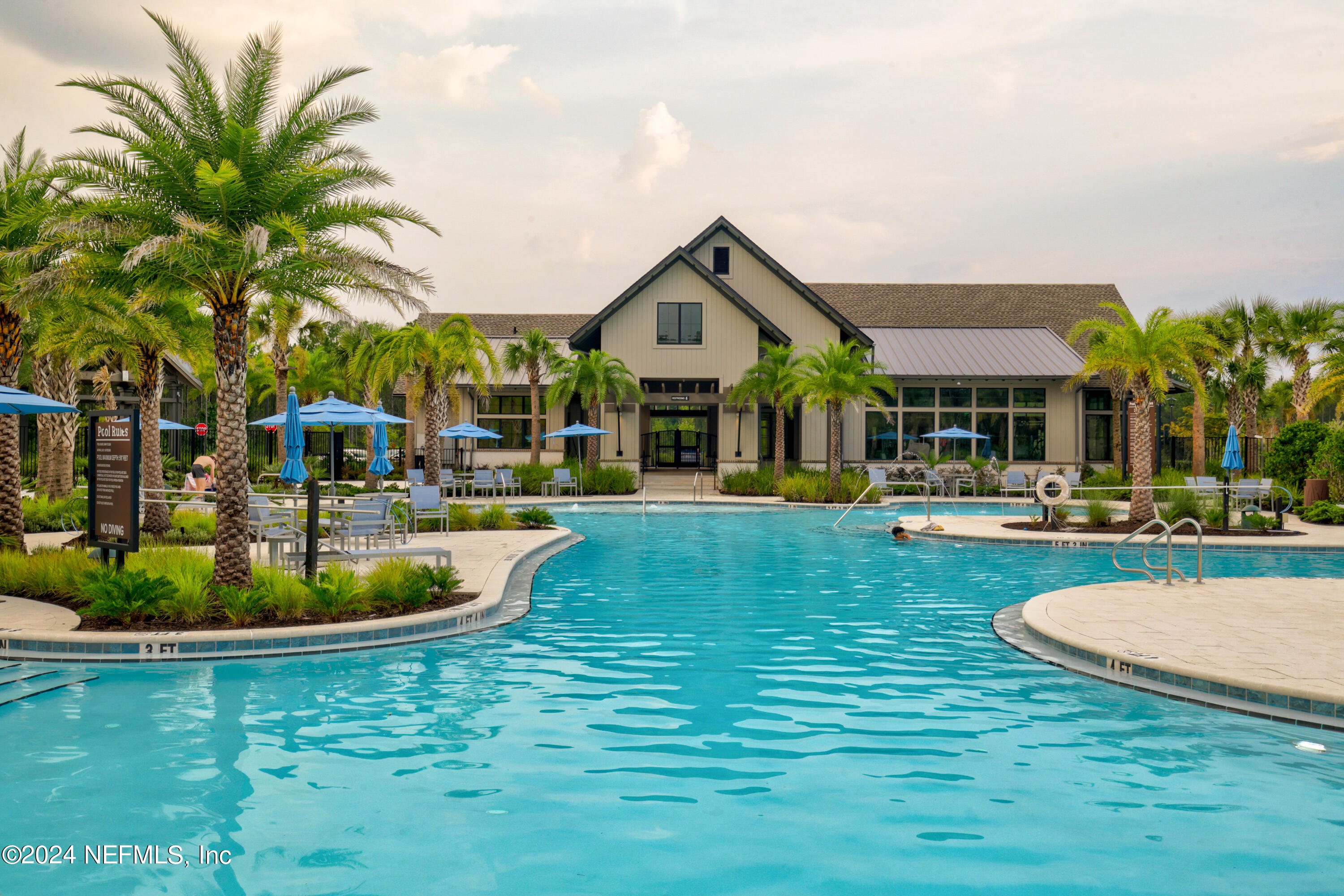 a front view of a house with garden and swimming pool