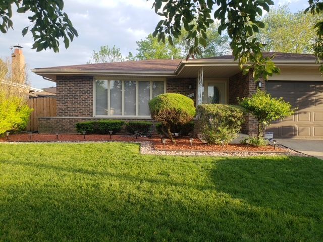 a front view of a house with a yard and porch