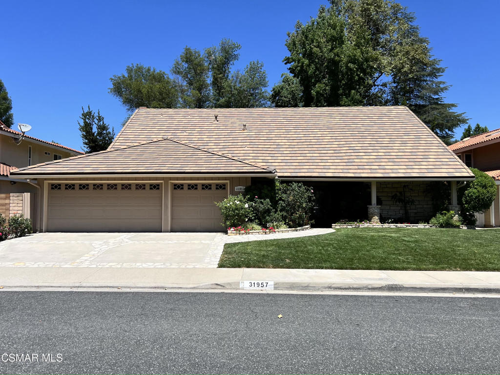 a front view of a house with a yard garage and outdoor seating