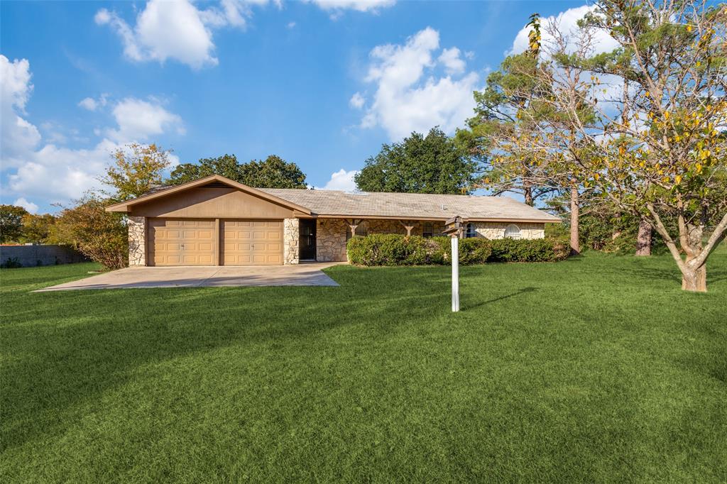 a backyard of a house with table and chairs