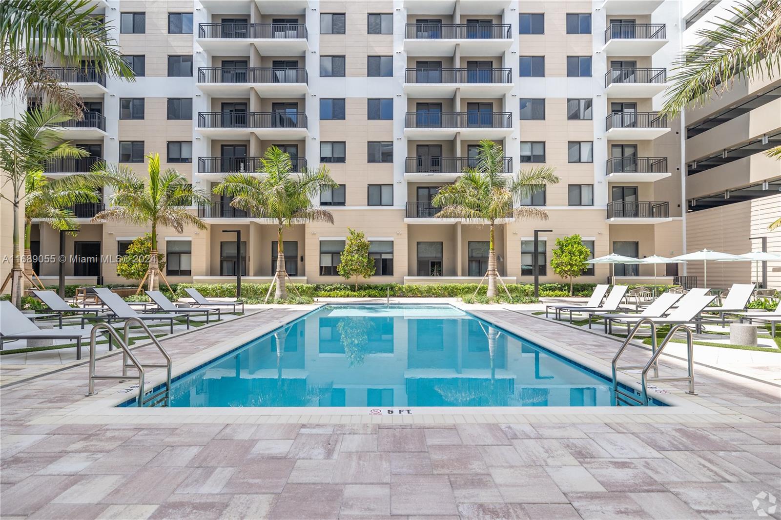 a swimming pool view with a outdoor seating