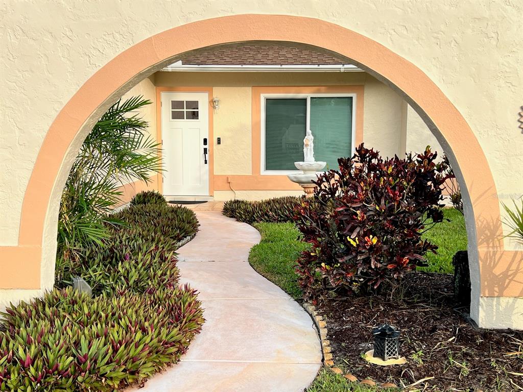 a front view of a house with a flower garden